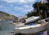 Boats & fishing boats in front of boat houses