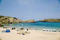 Arenal D' en Castell Beach protected by the headlands of the horseshoe bay